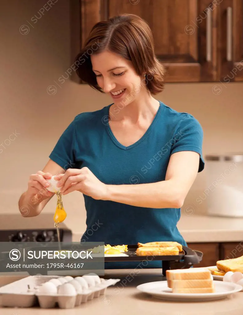 Woman preparing breakfast in kitchen