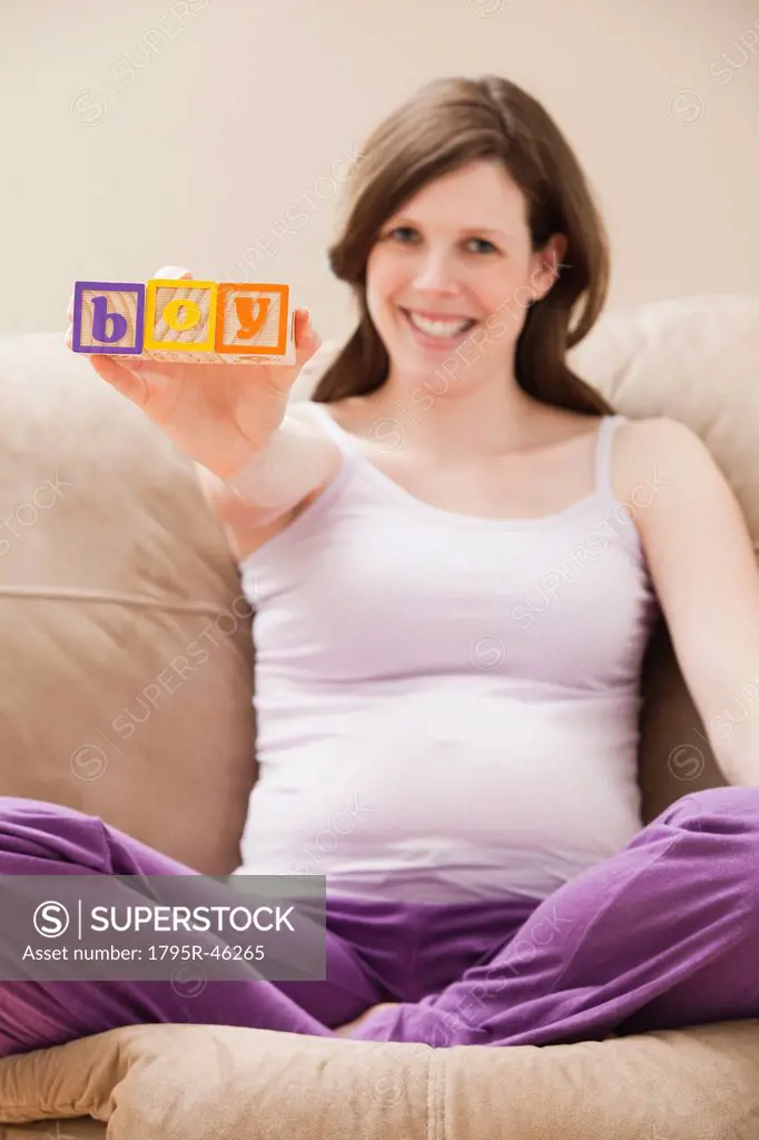 USA, Utah, Lehi, Young pregnant woman holding plastic letters reading: ´boy´