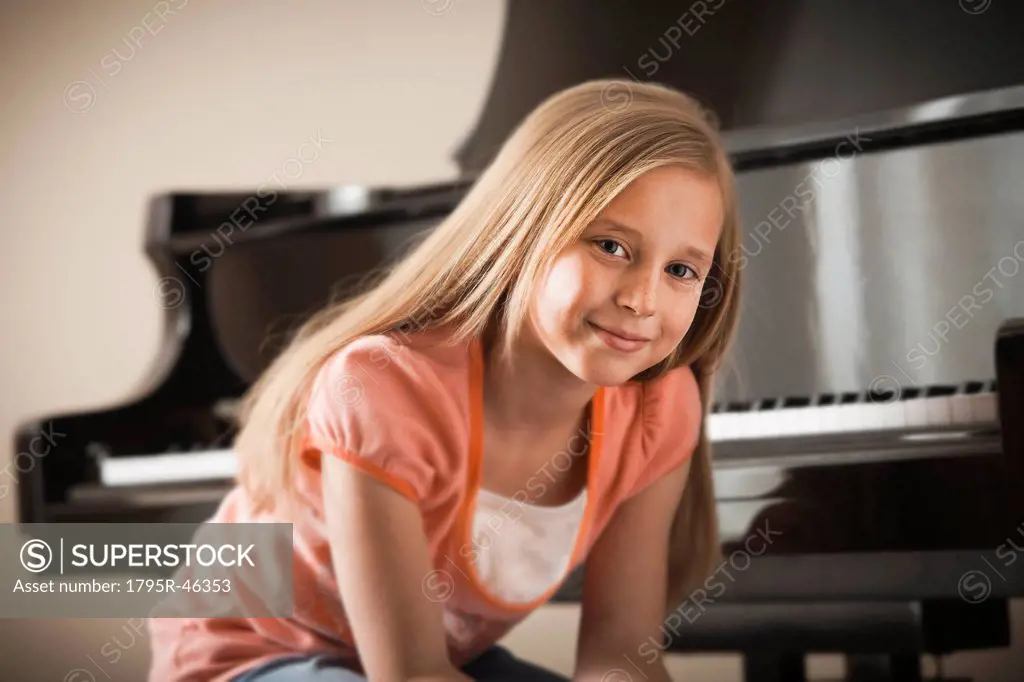 USA, Utah, Lehi, Portrait of girl 8_9 sitting by piano