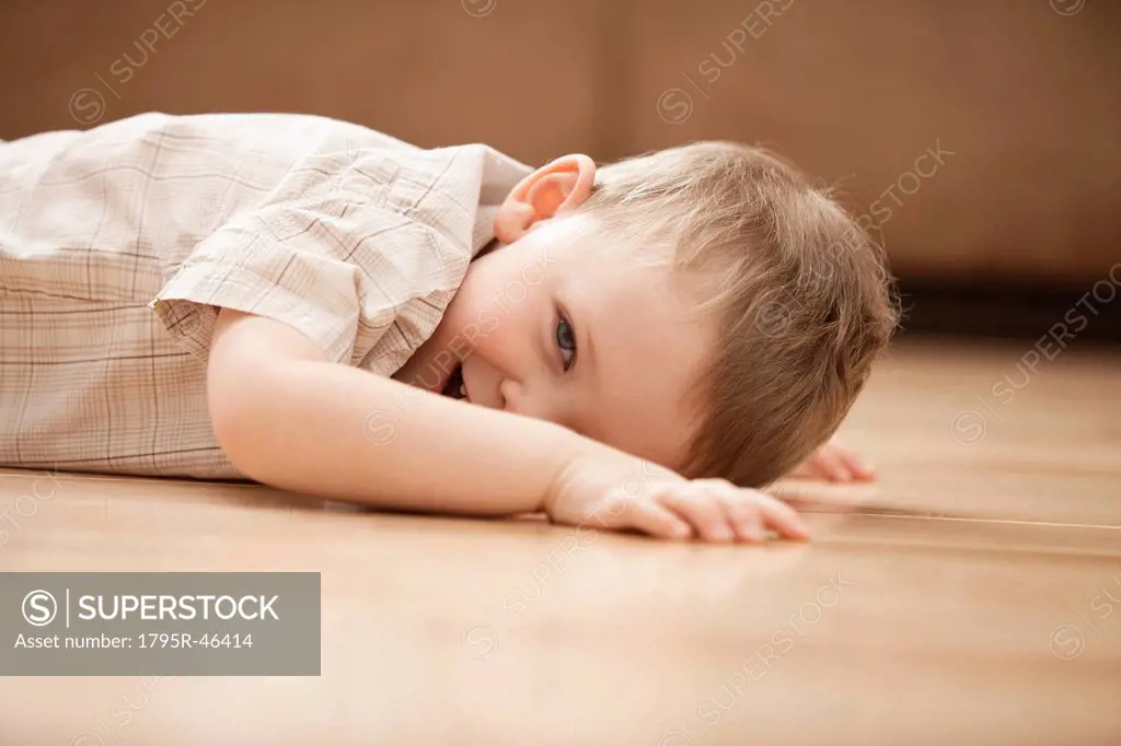 USA, Utah, Lehi, Portrait of smiling boy 2_3 lying on floor