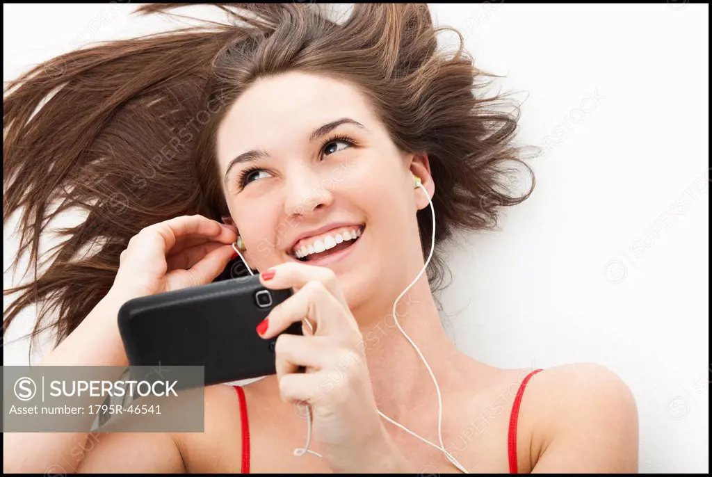 Young woman listening to mp3 player