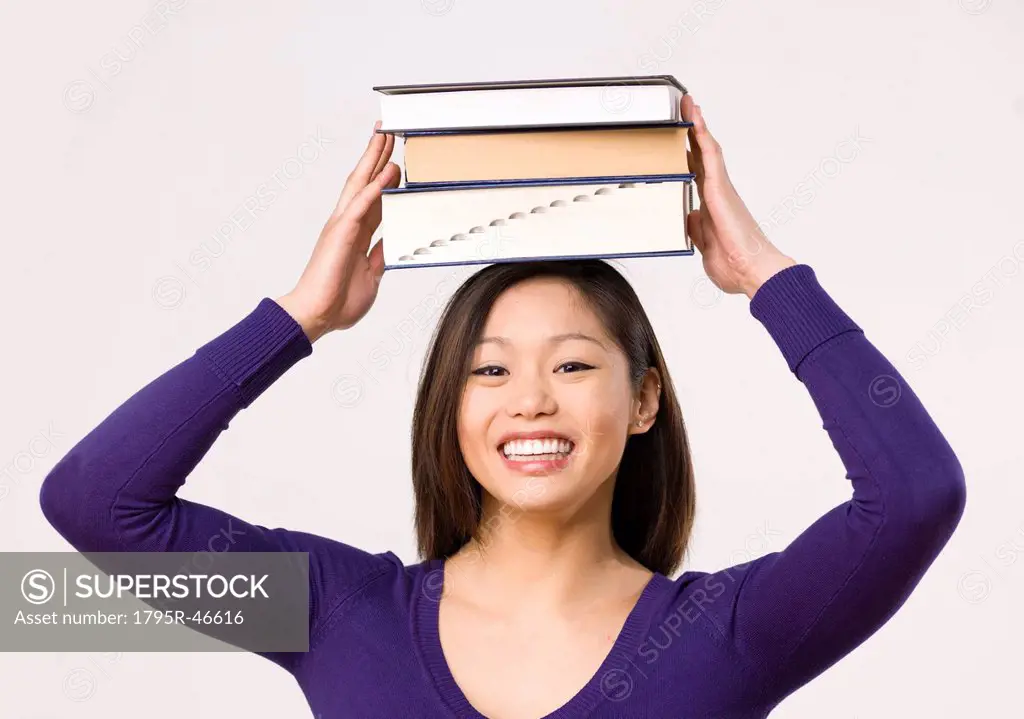Female student carrying book on head