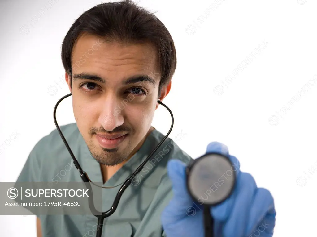 Young surgeon holding stethoscope