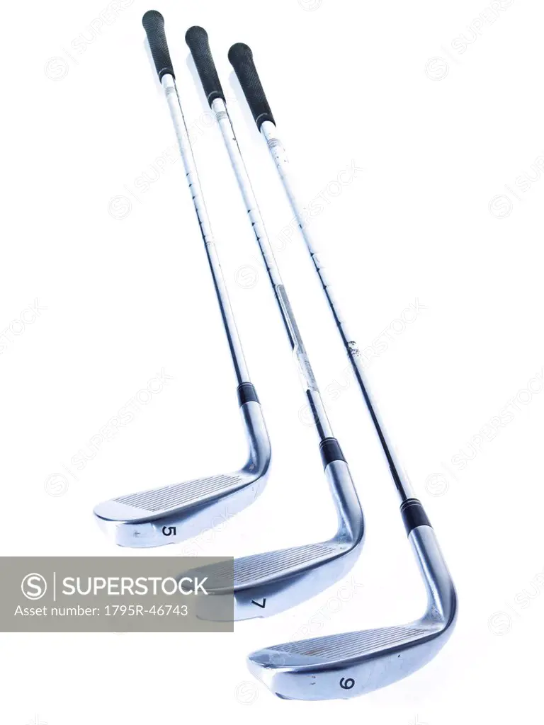 Three golf clubs on white background