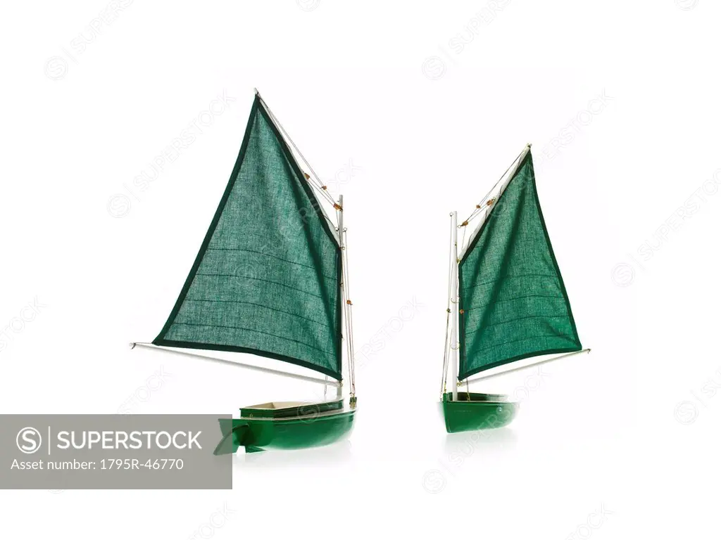 Two toy boats on white background