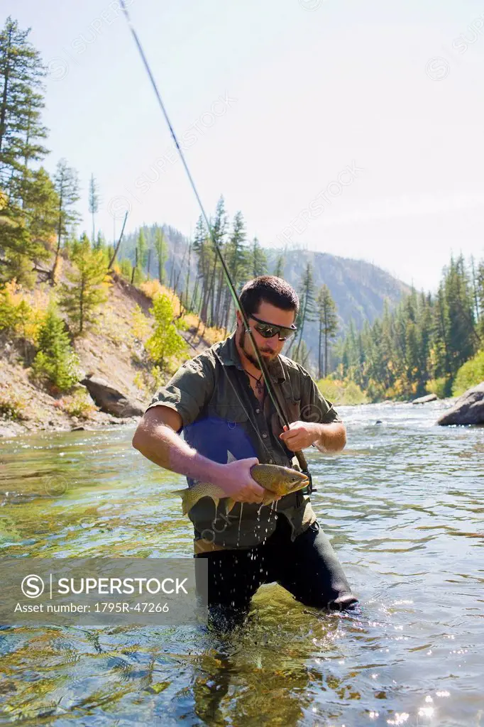 USA, Montana, Man fly fishing in North Fork of Blackfoot River