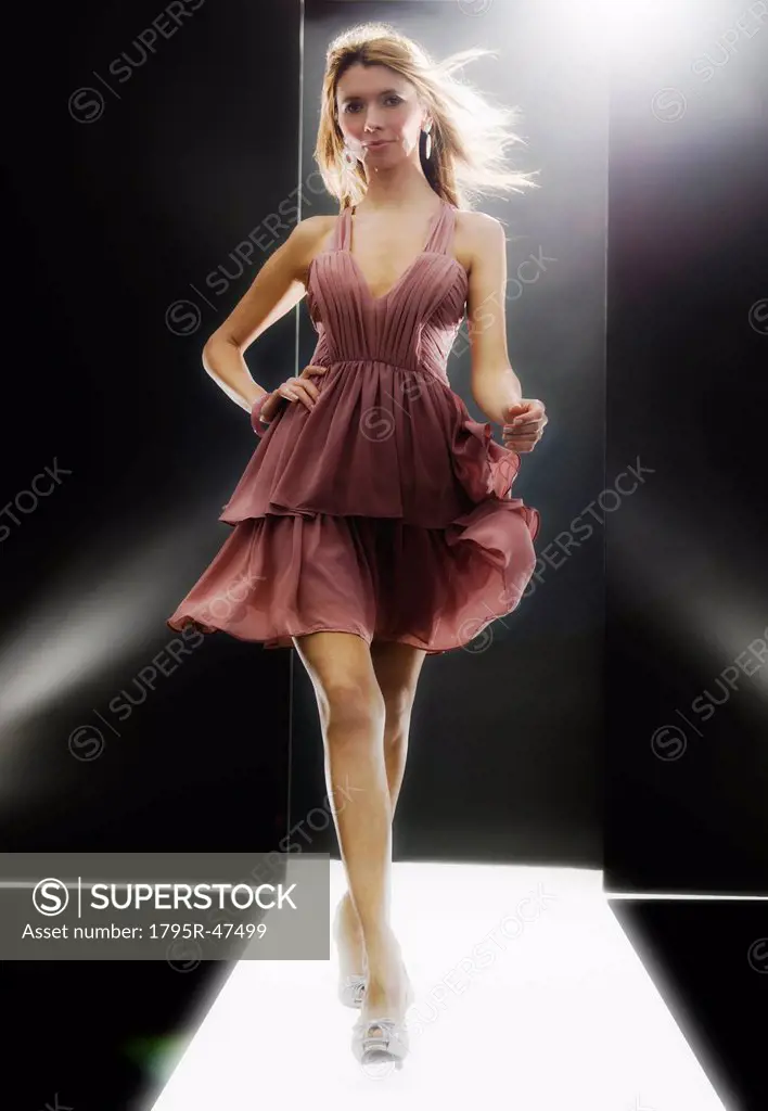 Female fashion model wearing dress on catwalk