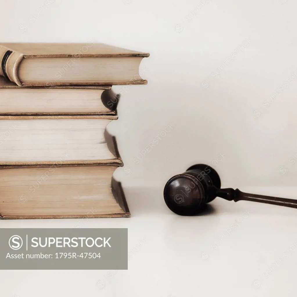 Judges gavel beside stacked law books