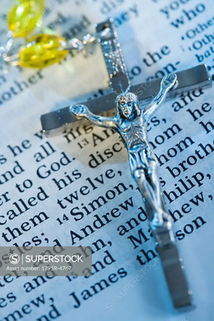 Close-up of crucifix with rosary on Bible