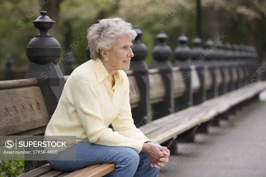 Portrait of woman sitting on park bench