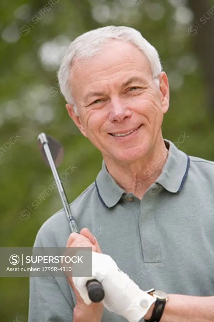 Portrait of senior man with golf club