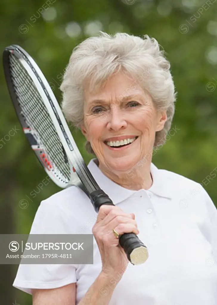 Portrait of senior woman with tennis racquet
