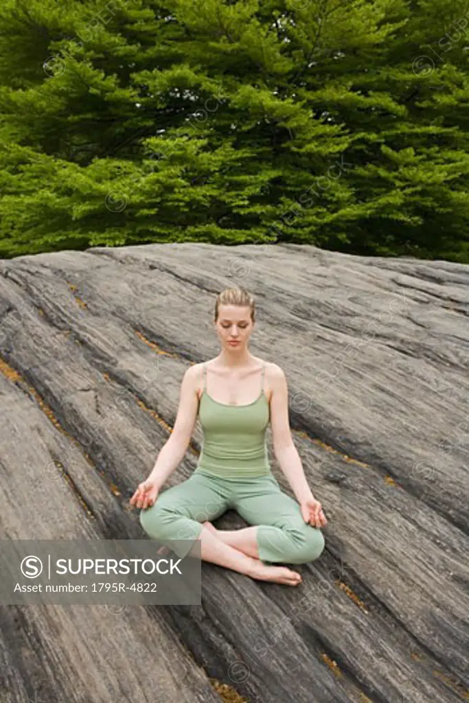 Woman practicing yoga in park