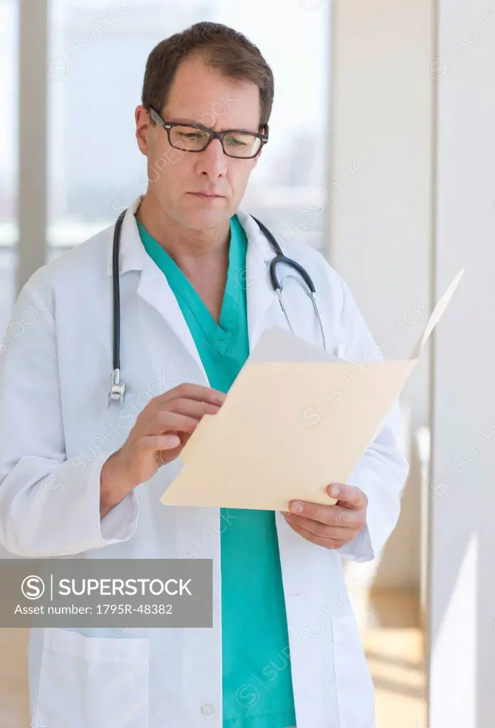 Doctor writing in clipboard