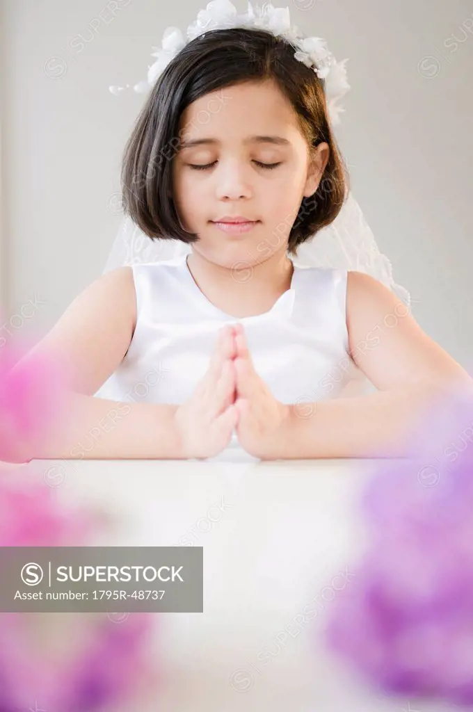 Portrait of girl 8_9 praying during Fist Communion