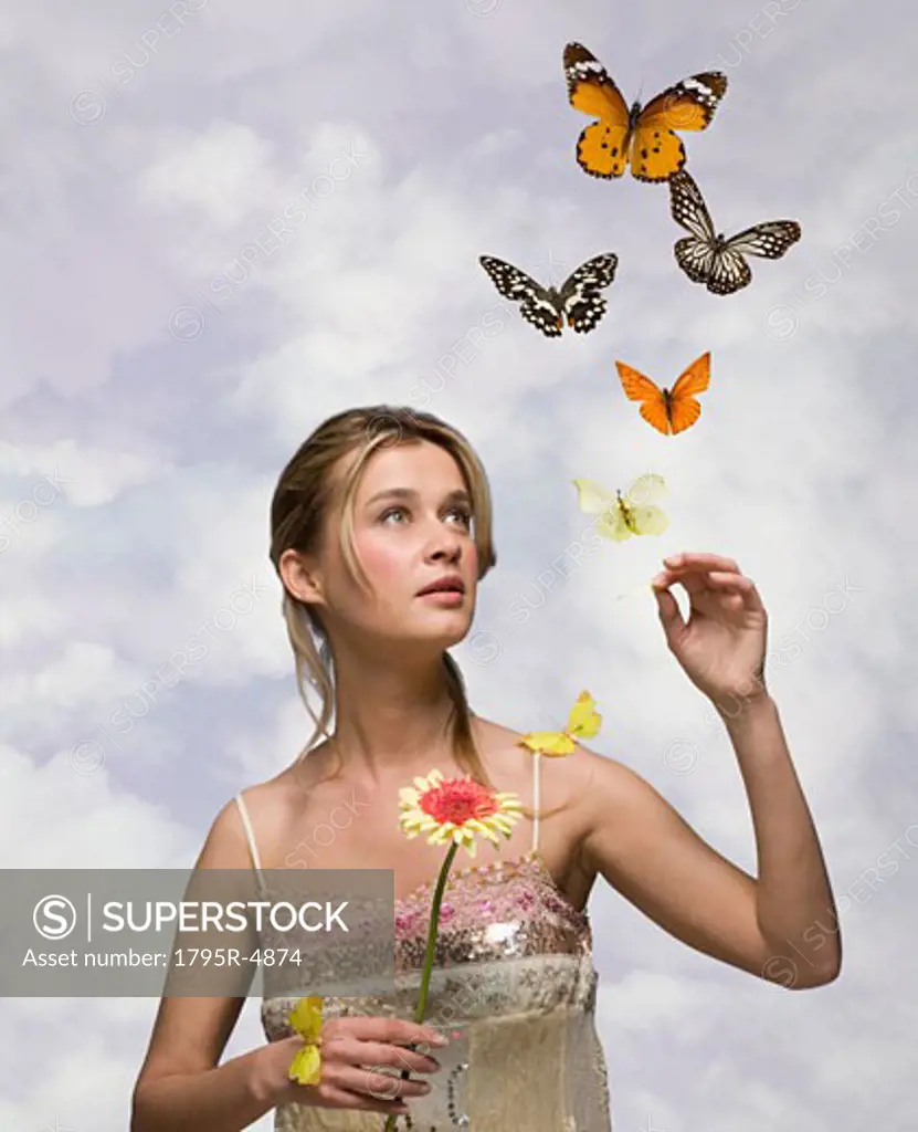 Young woman with flower and butterflies