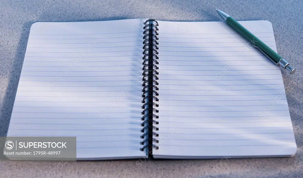 Blank open notebook and pencil