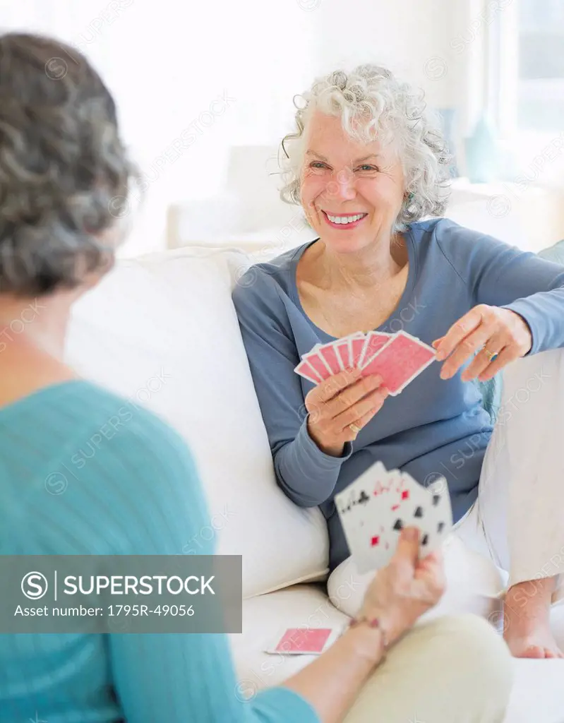 Two senior women playing cards