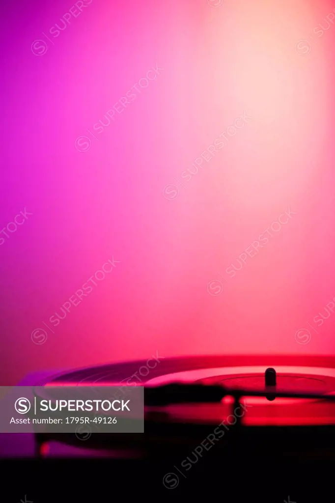 Close up of turntable on pink background