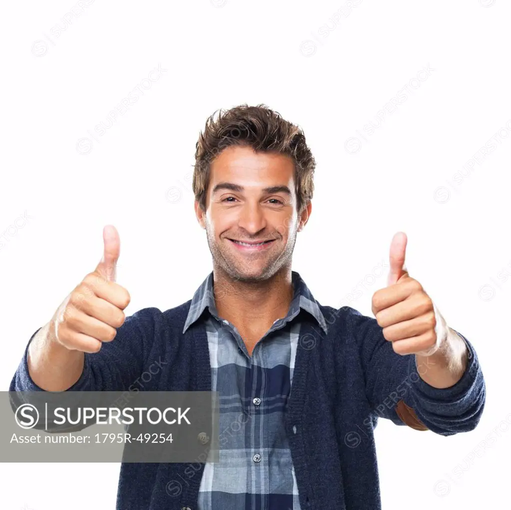 Studio shot of young man with two thumbs up