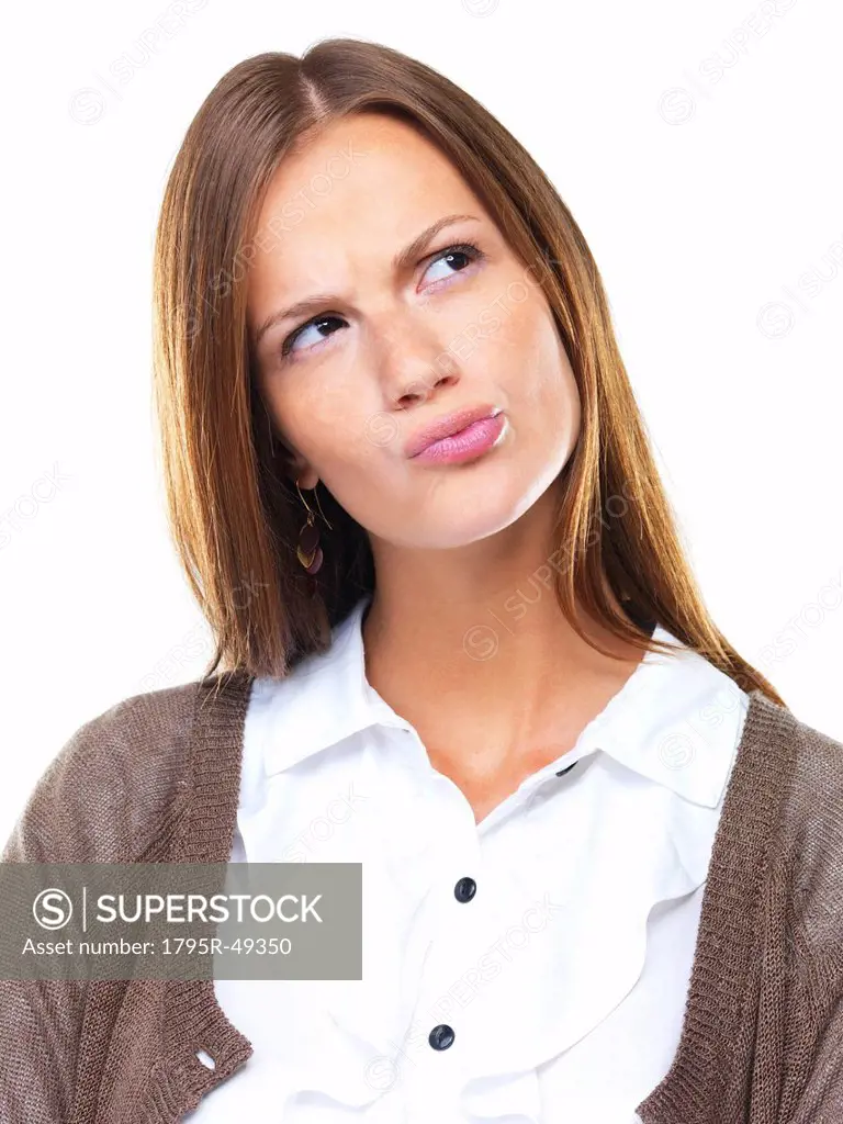 Close_up of business woman in doubt pursing her lips and looking away