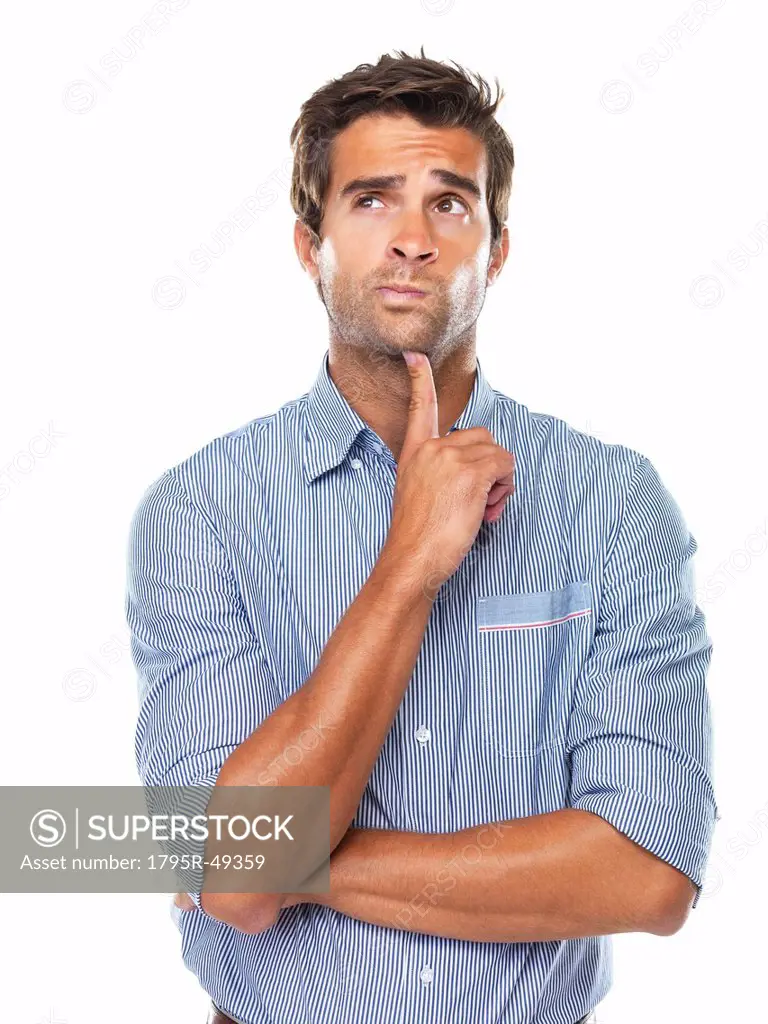 Thoughtful business man with finger on chin looking away