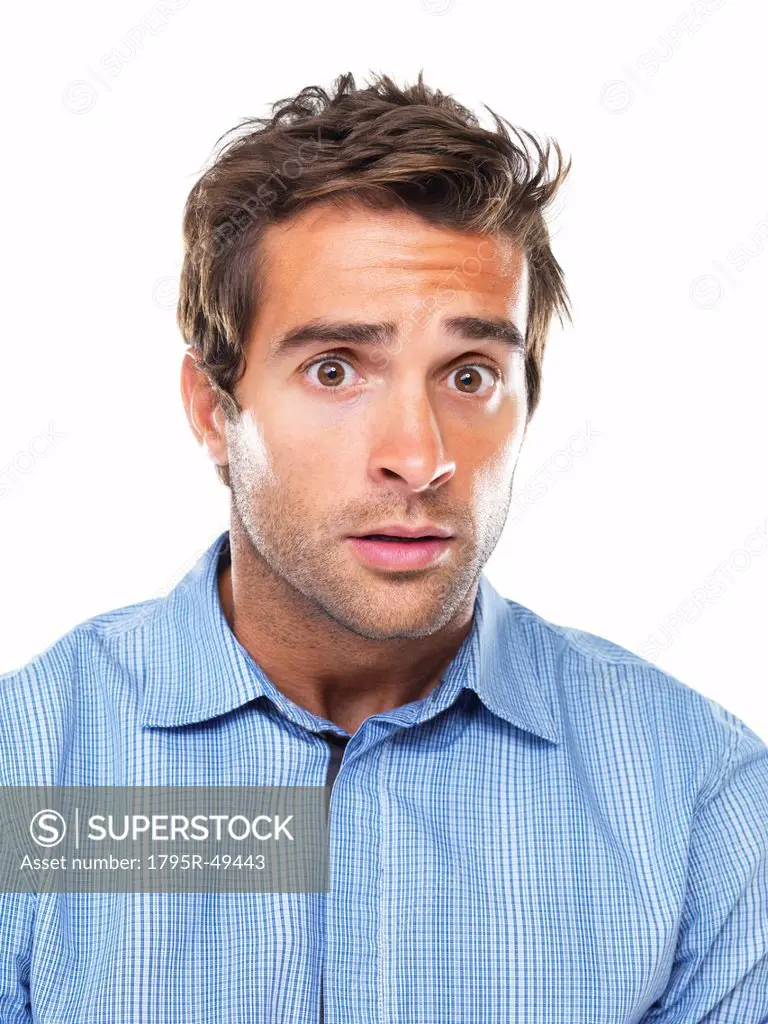 Studio portrait of young of shocked business man
