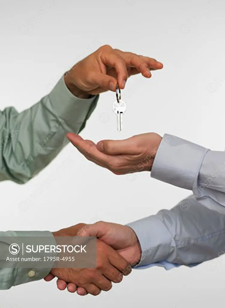 Two men closing deal and handing over keys