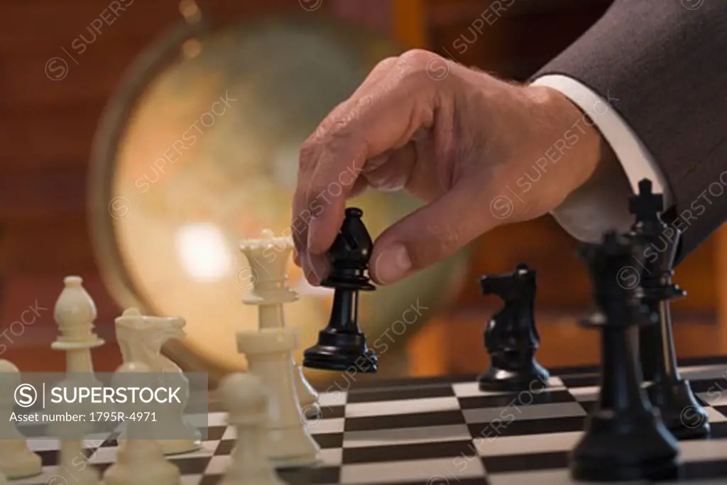 Businessman moving chess piece