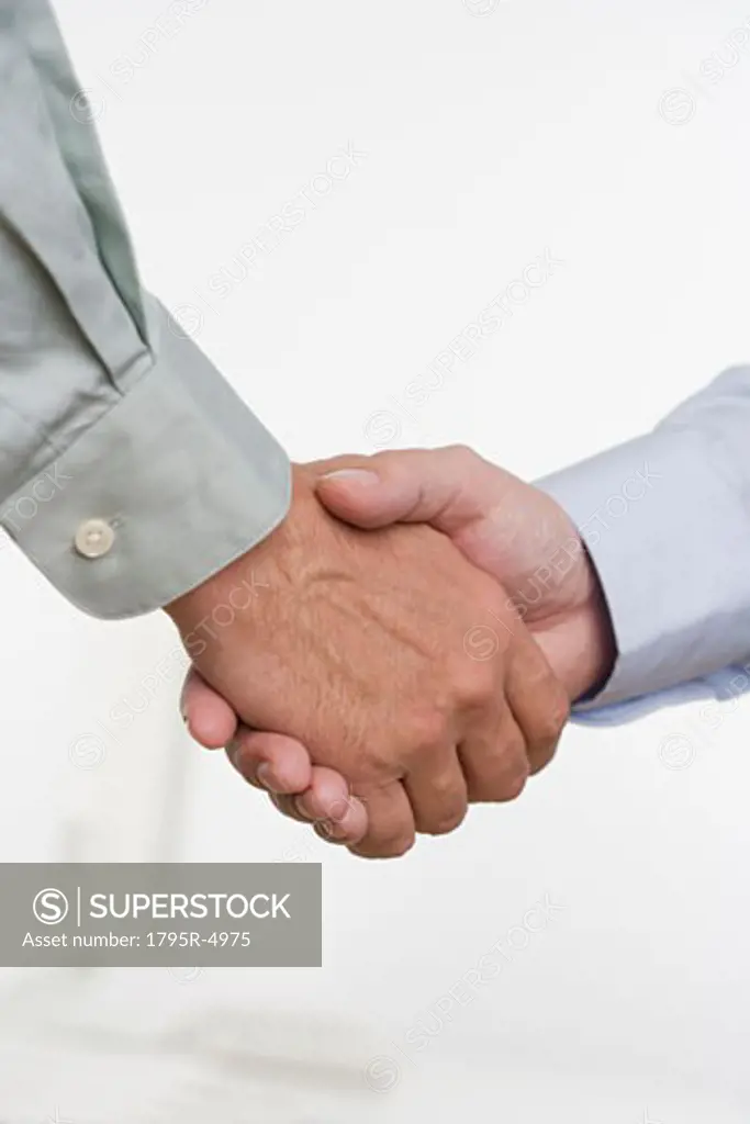 Men in shirtsleeves shaking hands
