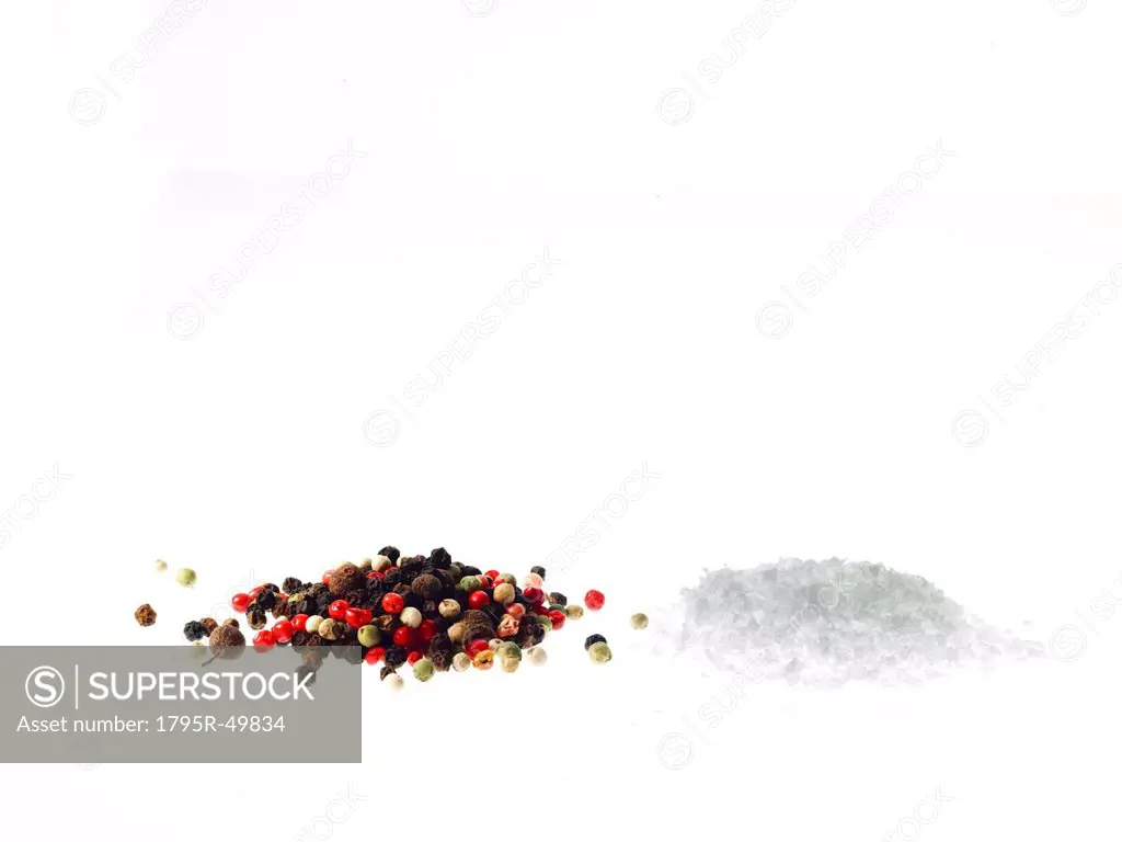 Studio shot of mixed pepper corns and coarse salt