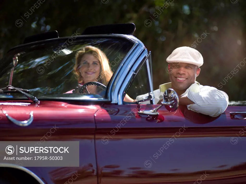 Smiling couple driving classic´s car