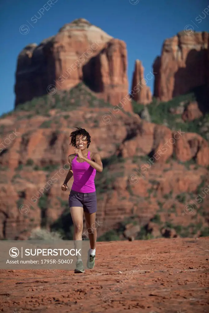 USA, Arizona, Sedona, Young woman running at desert