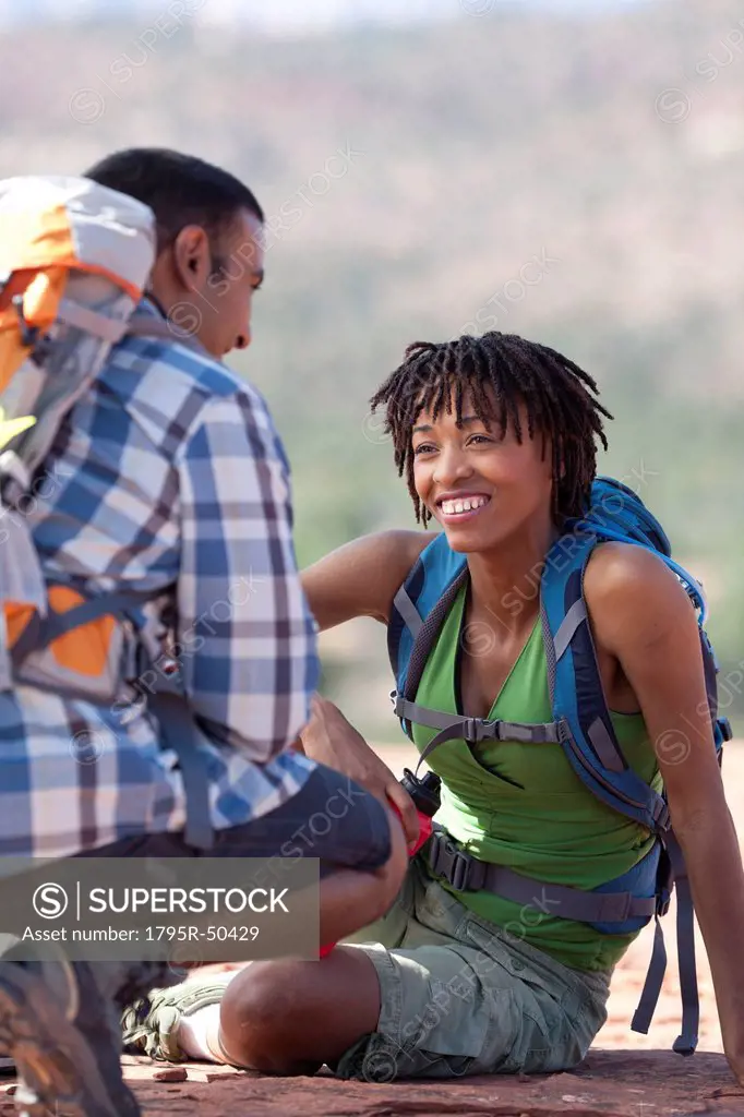 USA, Arizona, Sedona, Young couple hiking and enjoying desert scenery