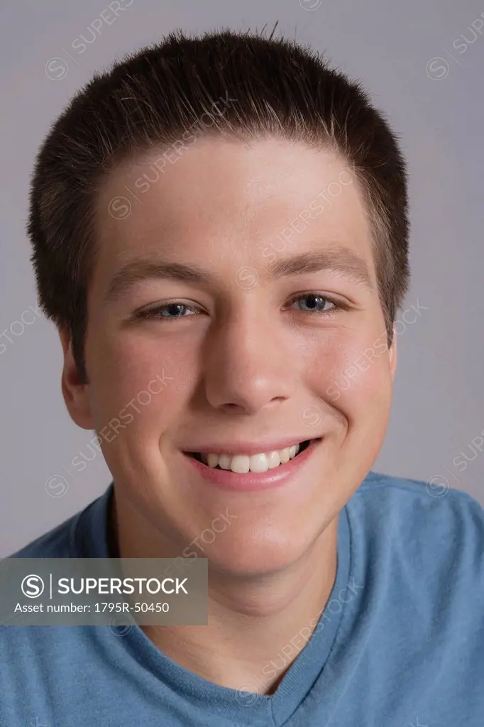 Portrait of smiling teenager, studio shot