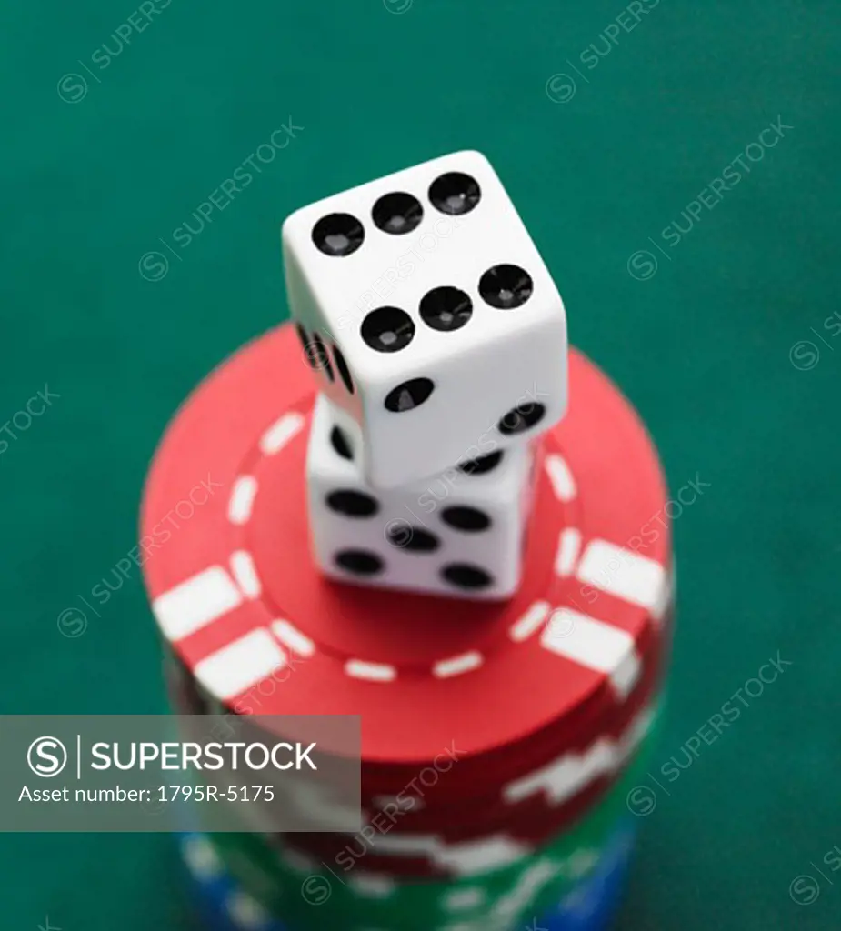 Close-up of dice on stack of poker chips
