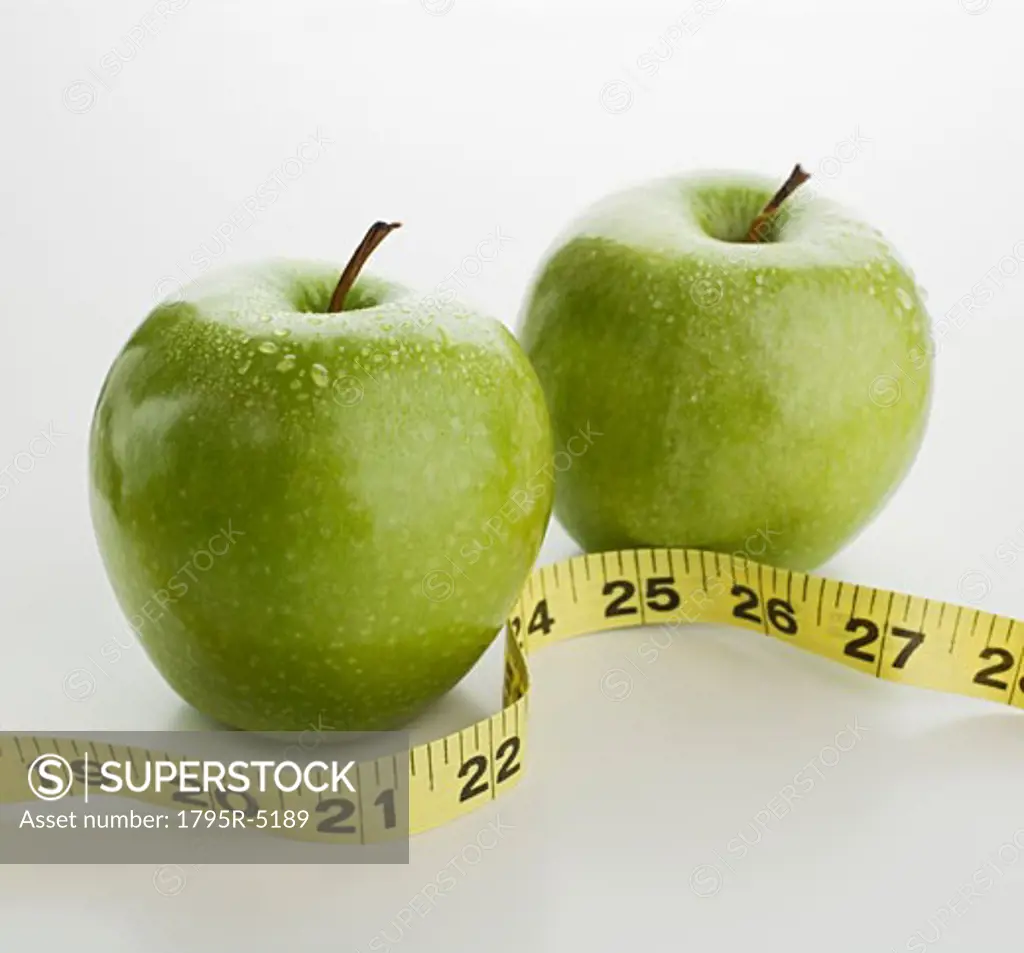 Studio shot of apples and tape measure