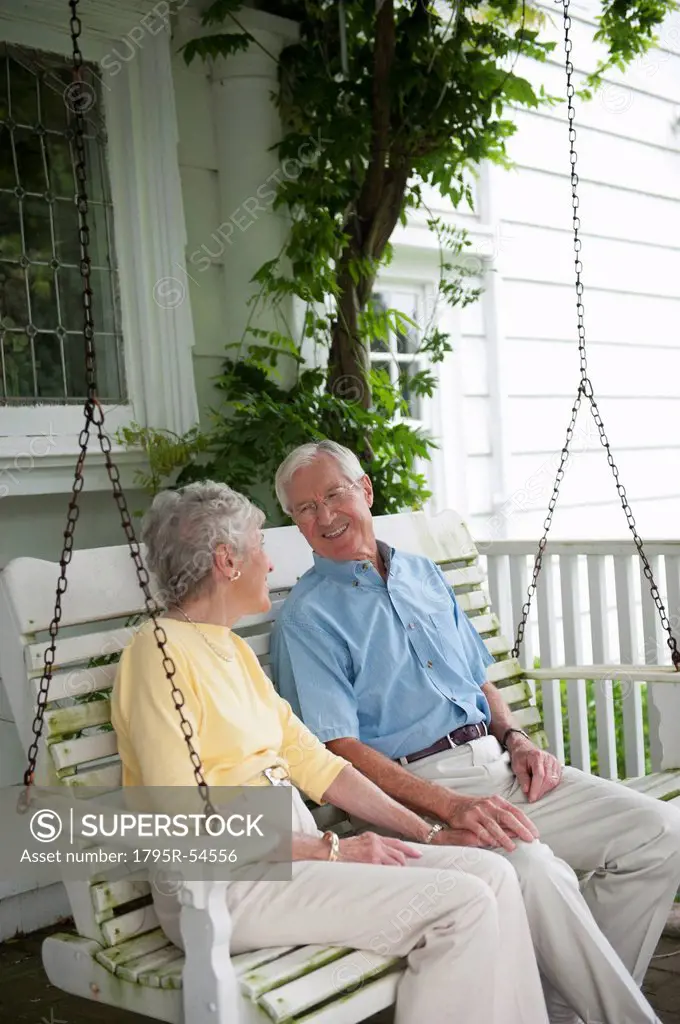 Senior couple sitting on porch swing