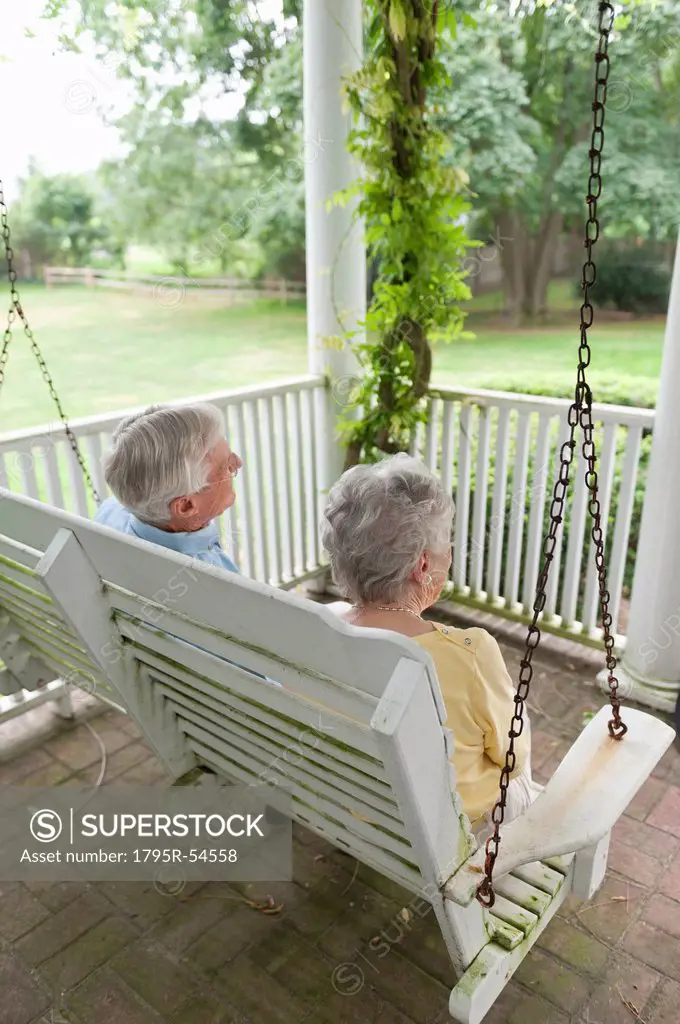 Senior couple sitting on porch swing