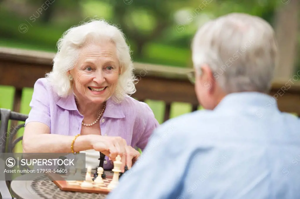 Seniors playing chess on porch