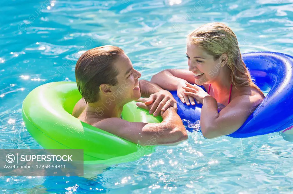 Portrait couple in swimming pool
