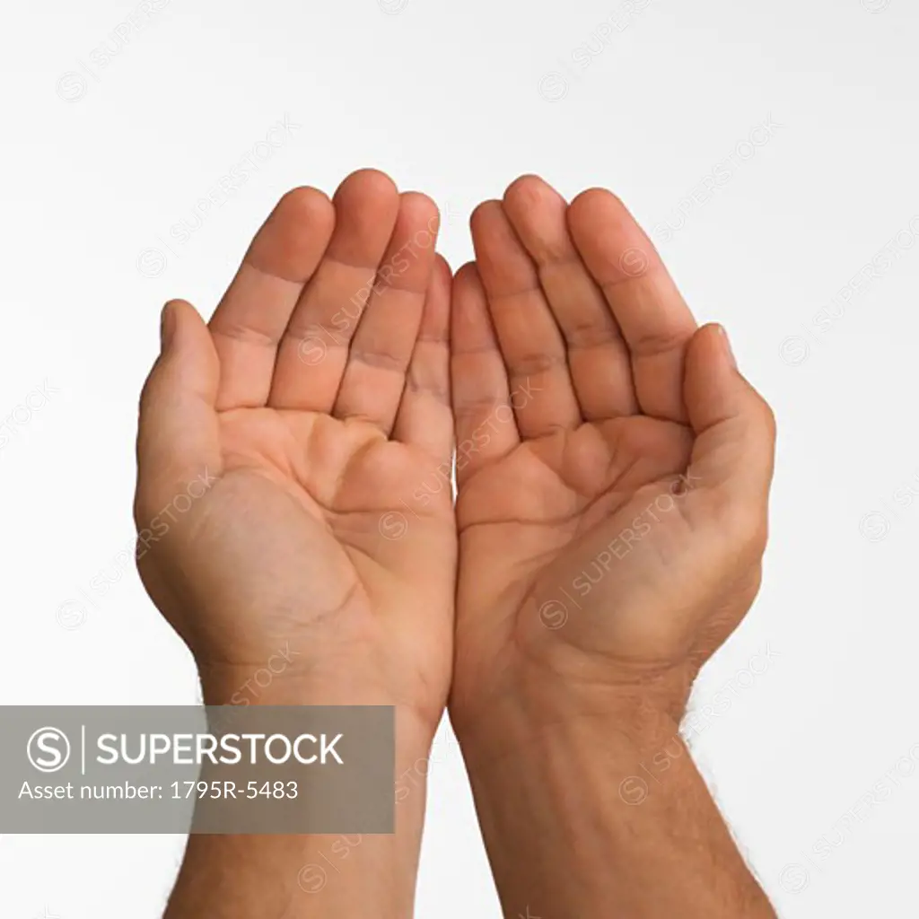 Close-up studio shot of man's cupped hands