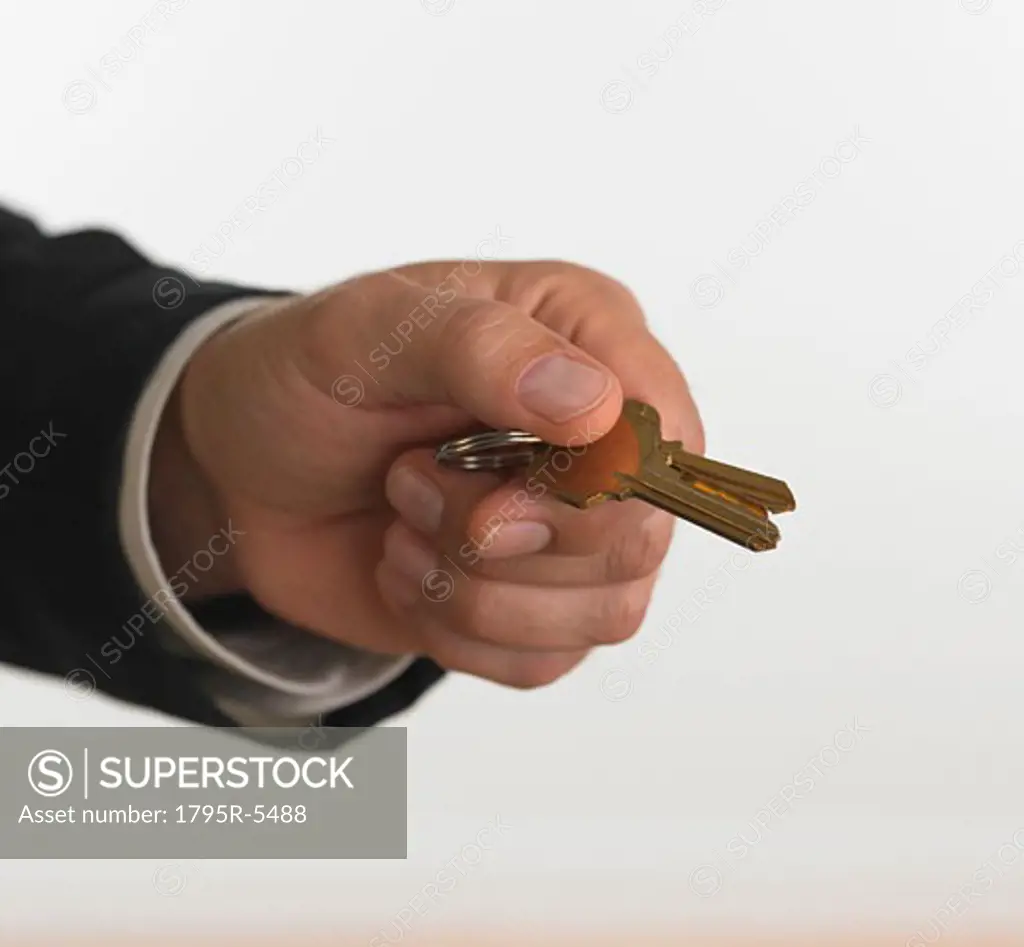 Studio shot of businessman holding keys