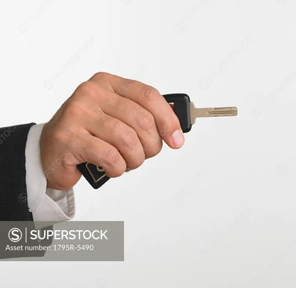 Studio shot of businessman holding car keys