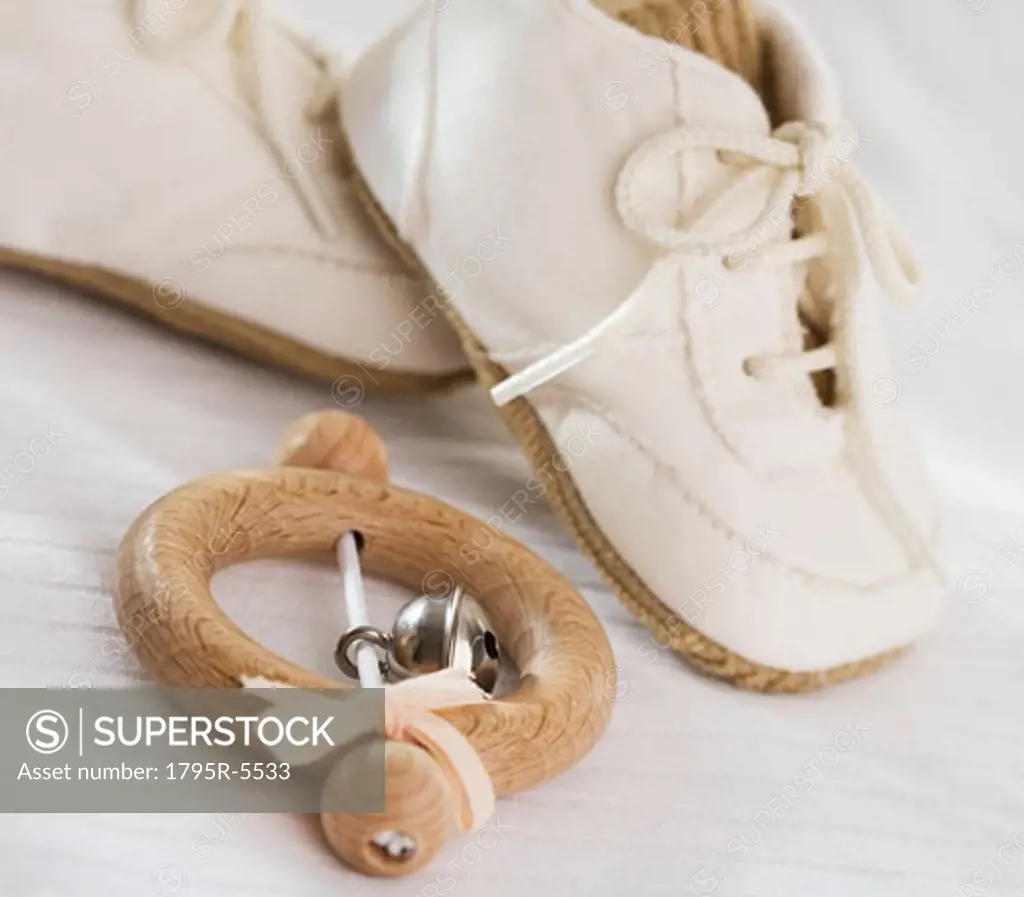 Close-up of baby rattle and baby shoes