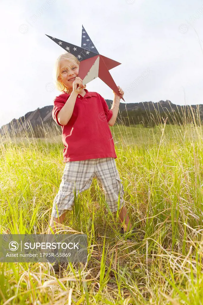 Boy 6_7 playing with star with American flag pattern