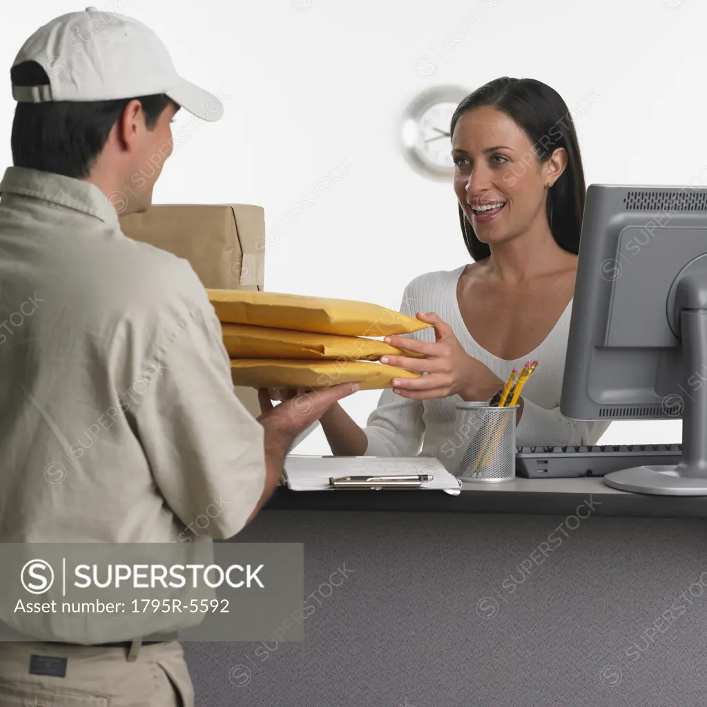 Woman behind counter receiving delivery