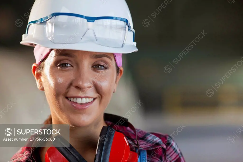 Portrait of female manual worker wearing hardhat
