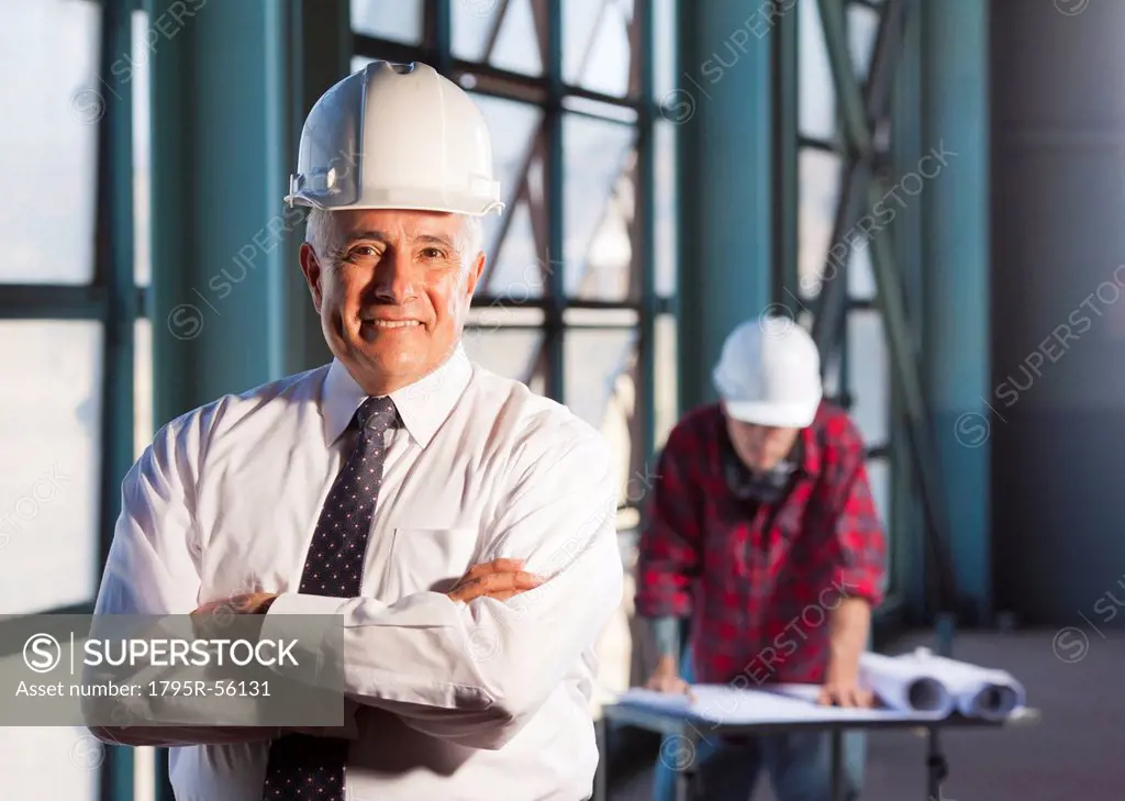 Portrait of man wearing tie and hardhat