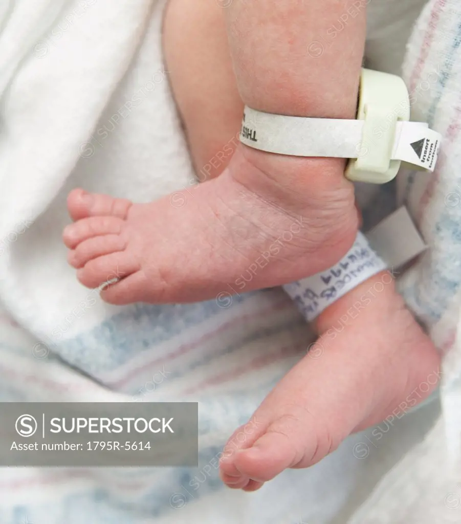 Newborn baby's feet with hospital tags